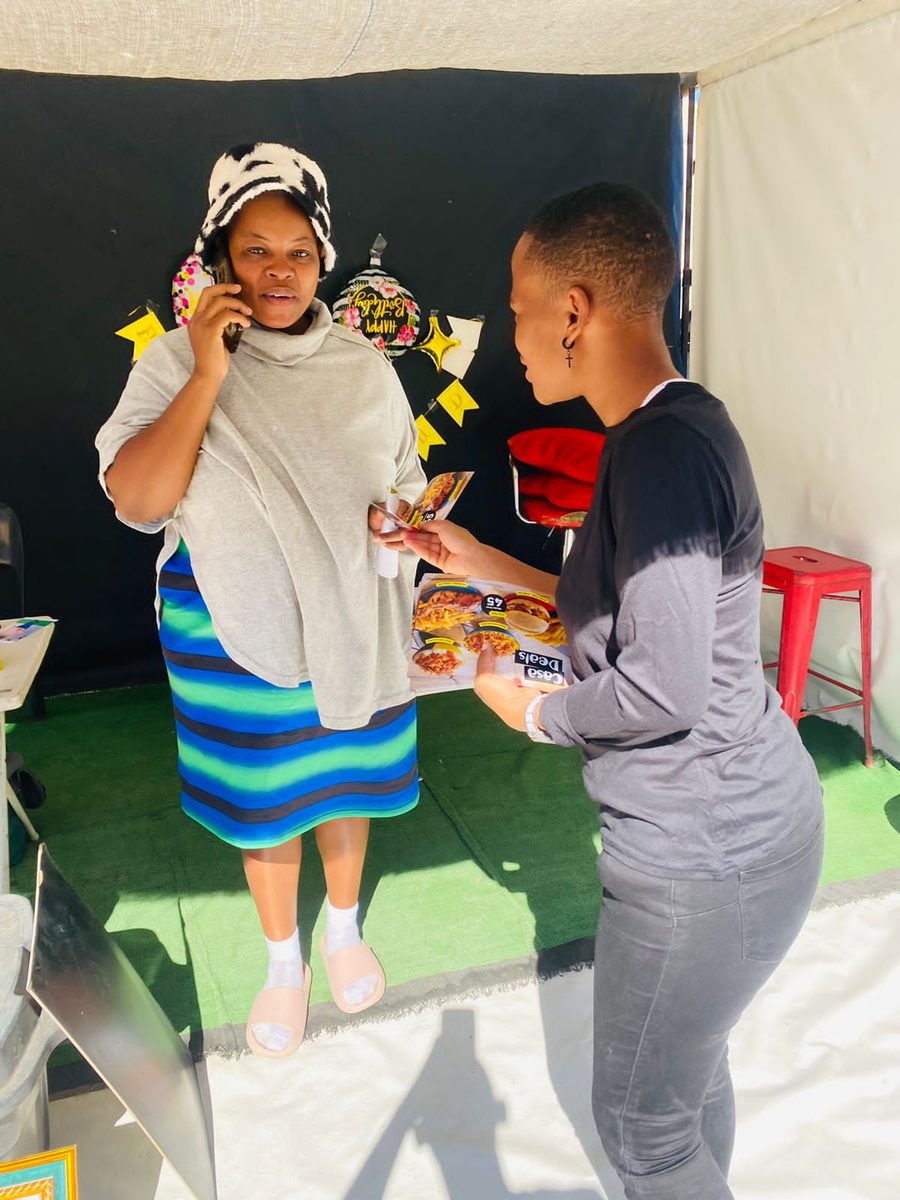 Brand ambassador engaging a guest at a Nando's in-store activation